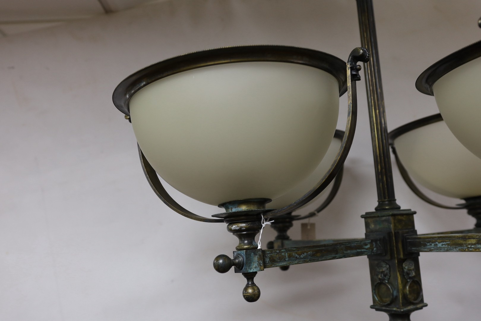 A brass 4 branch ceiling light with opaque glass shades, 72 cms high x 94 cms wide.